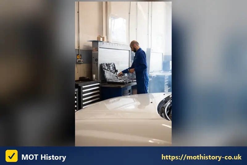 Mechanic choosing tools from a toolbox in a garage - check car service history