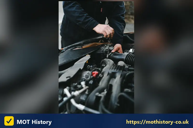 Close view of hands servicing an engine - free mot test