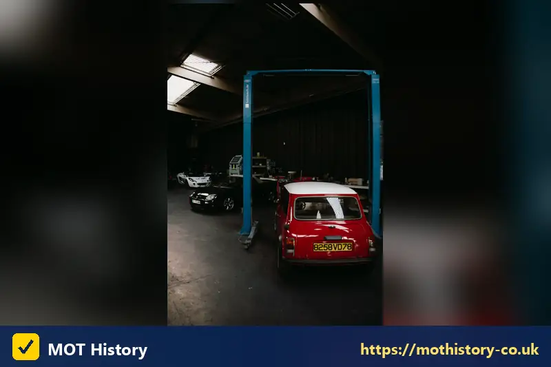 Red classic Mini on a garage lift - mot test exemption