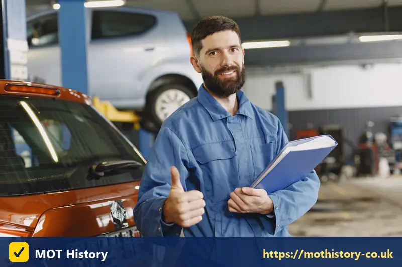 Smiling mechanic holding a folder beside a car - motorcycle vin check