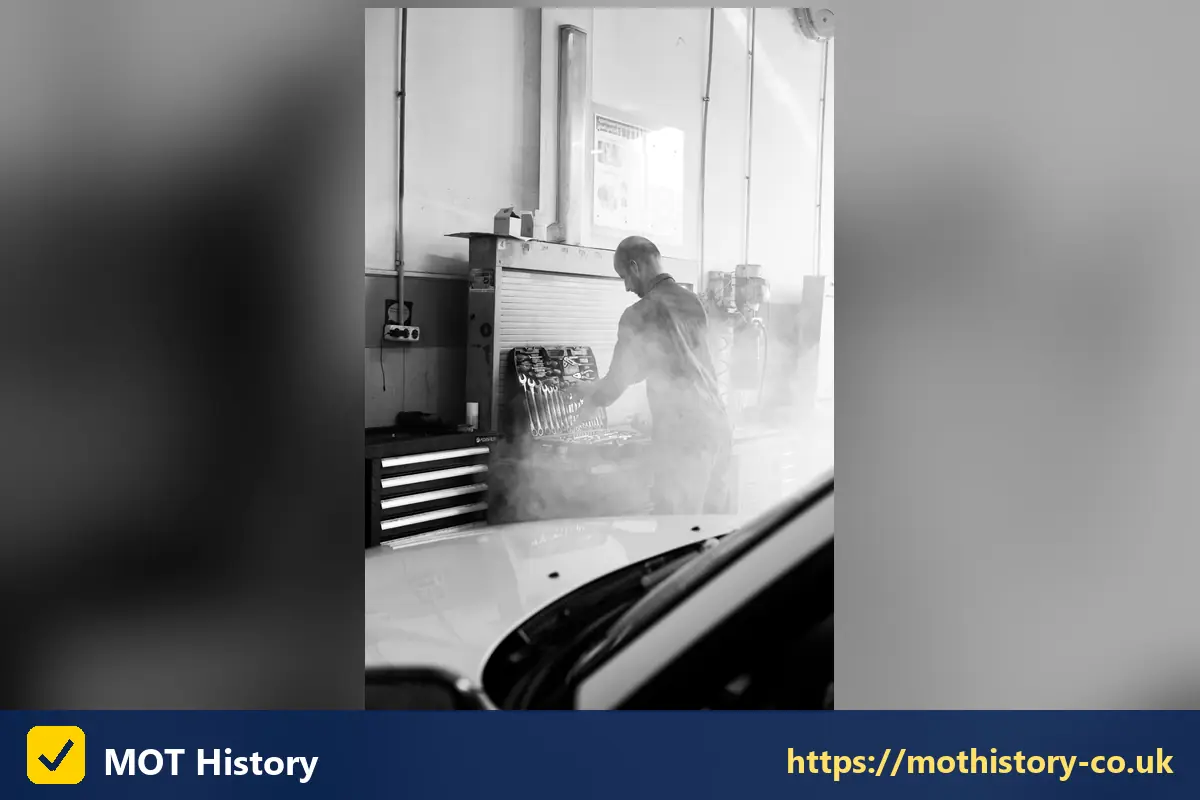 Mechanic working in a steamy garage bay - car service history