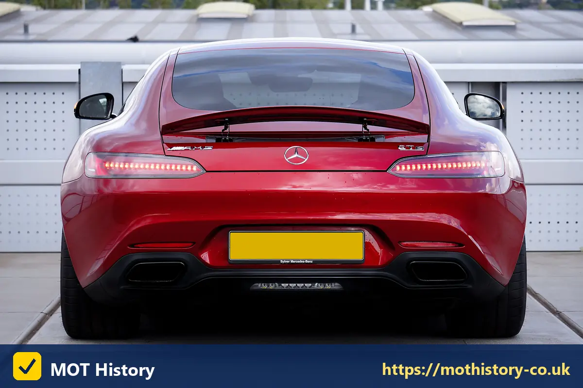 Rear of a red sports car with a yellow number plate - low cost registration plates